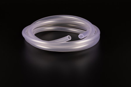 transparent plastic tube coil on black backgroundの写真素材
