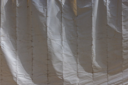 Old cracked white building cover tarp, full-frame background and textureの写真素材