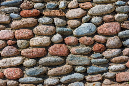 wall made of many colorful round stones, full-frame background and textureの写真素材