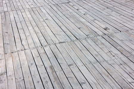 Closeup of a sun-bleached grey hardwood deck floorの写真素材