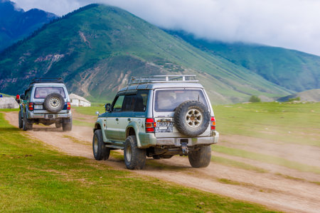 OffRoad Adventure in the mountain ravine SUVs Driving on a Dusty Dirt Roadのeditorial素材