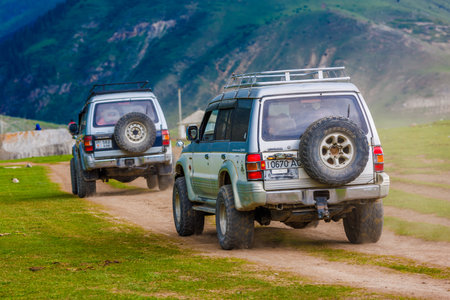 OffRoad Adventure in the mountain ravine SUVs Driving on a Dusty Dirt Roadのeditorial素材