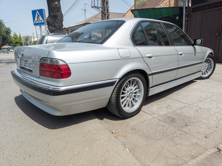 perfectly saved silver BMW 740i E38 on sunny summer streets of Bishkek, Kyrgyzstanのeditorial素材