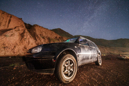 old black car at starry summer night in the desert