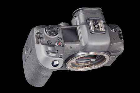 black professional mirrorless camera body isolated on black background