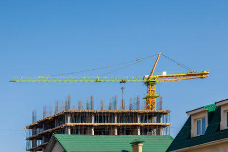An Urban Construction Site Featuring a Large Crane and an Emerging New Building Structureの写真素材