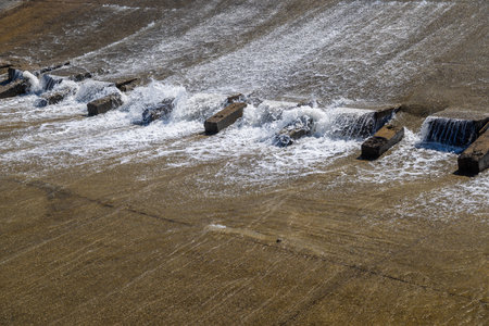 chute dentate blocks in concrete water spillway channelの写真素材