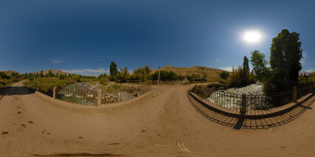 Spherical HDRi panorama of an old dusty bridge over mountain river at sunny autumn day