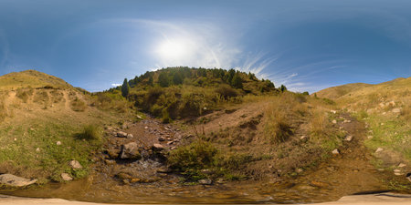 Spherical HDRi panorama of small mountain creek in autumnal valley between yellow foothills