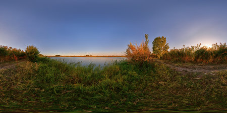 Full Spherical panorama of small pond shore at beautiful autumnal sunset at countryside in equirectangular projectionの写真素材