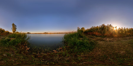 Full Spherical panorama of small pond shore at beautiful autumnal sunset at countryside in equirectangular projectionの写真素材