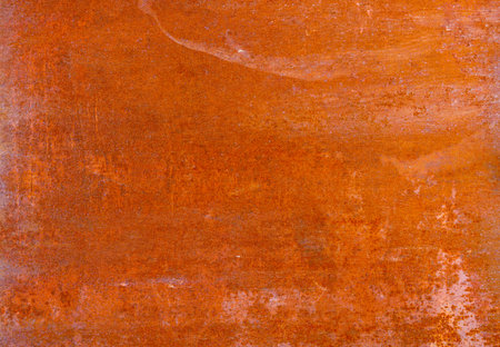 Close-up of a consistently rusted metal surface displaying a relatively even texture with variations...