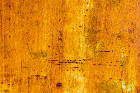 Extensive rust on a metal surface with vertical white paint leftovers and dark corrosion spots