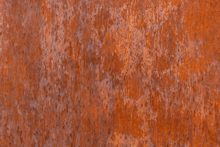 Homogeneous orange rusted flat sheet metal surface with a consistent grainy texture and subtle...