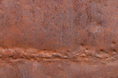 dented and crumpled rusty sheet metal texture and full-frame background with rust cavities