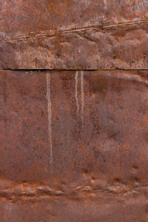 dented rusty overlapping metal sheets texture and full-frame background with rust cavities