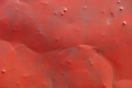 Dented Badly Painted Red Sheet Metal Texture and full-frame background