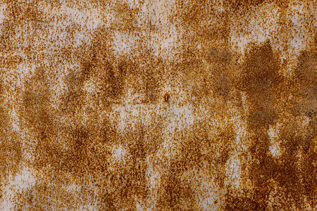 Weathered metal surface covered in rust, showcasing a grunge aesthetic. Outdoor setting under clear...