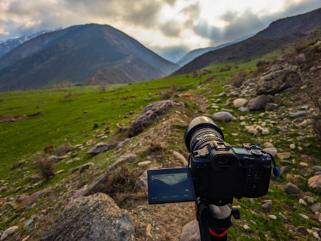 Camera focuses on stunning landscape in a mountainous region during daytime. Peaceful scenery evokes...