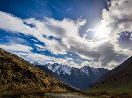 Serene snow-capped Kyrgyzstan mountains in peaceful valley landscapeの写真素材