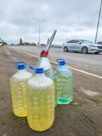 plastic bottles with gasoline on the side of the road, street gasoline reselling in Kyrgyzstanの写真素材