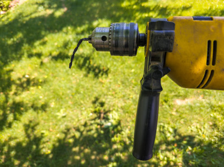 drill with bent drill bit in outdoor garden during daytimeの写真素材