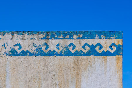 Weathered wall with rustic paint outdoors under clear skyの写真素材