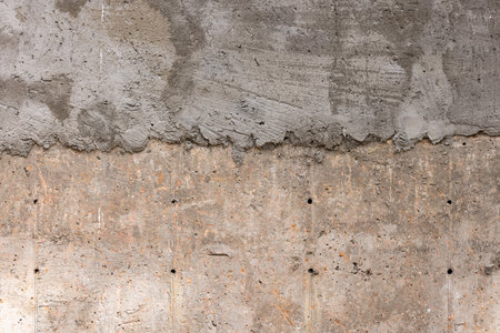 Rough dry composite concrete wall texture under construction in daylightの写真素材