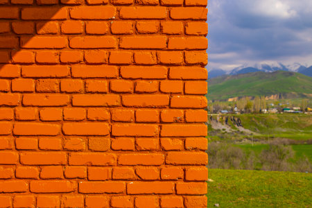 Orange brick wall in serene mountainous outdoor landscapeの写真素材