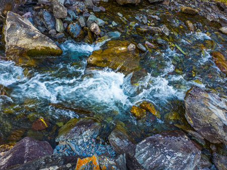 Flowing mountain stream with rocks in serene natureの写真素材