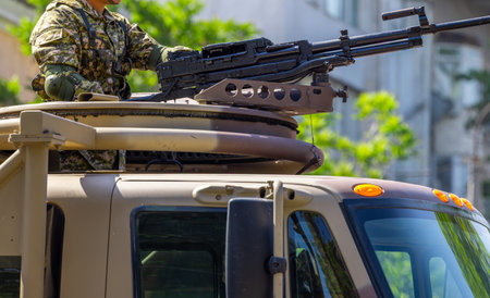 Male soldier operating heavy machine gun on vehicle outdoors