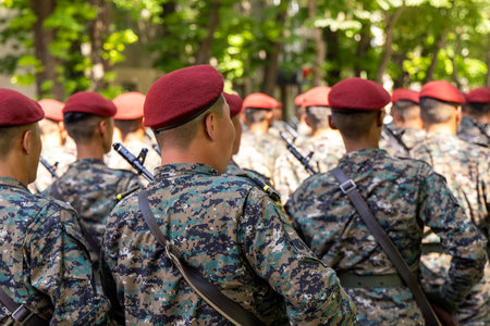 Young Asian men in military uniforms marching in formation outdoors
