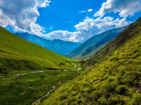 Majestic mountains and tranquil river in serene landscapeの写真素材