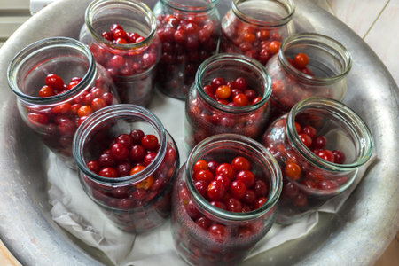 cherries in glass jars prepared for preservingの写真素材