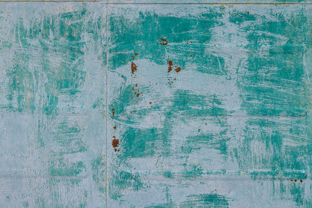 Weathered metal surface with rust and texture on outdoor wall