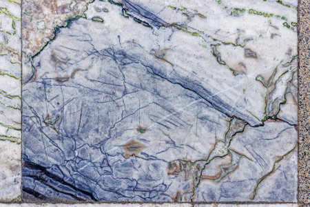 Worn Marble Floor Tiles with Intricate Blue and Green Veins
