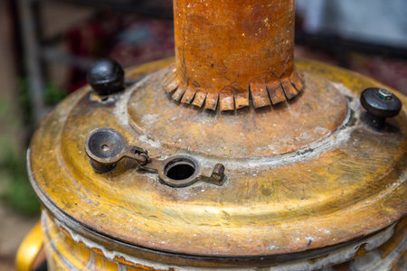 Antique brass samovar in garden with greeneryの写真素材