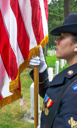 Female Military Honor Guard holding the staff of the American Flag at a Memoral Day ceremony at Ft. Lewis, Washington.  25 May, 2015.のeditorial素材