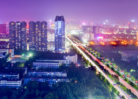 modern tall buildings and the road at nightのeditorial素材