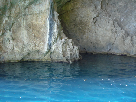 white cliff of a waterway cave overlooking the crystal clear sea. Taken in north western Greeceの写真素材