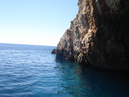 Cliffs of a navigable cave overlooking the crystal clear sea. Taken in north western Greeceの写真素材
