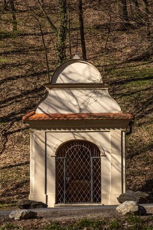 historic isolated chapel in the forest among the trees in the town of Marianka in Slovakia in autumnの写真素材