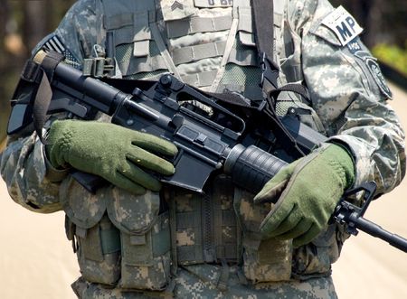 US soldier in camouflage uniform holding his rifleの写真素材