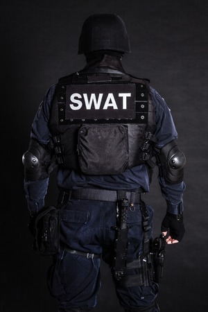 Special weapons and tactics (SWAT) team officer on black shot from behindの写真素材