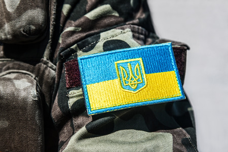military badge of ukrainian army with trident and yellow-blue flagの写真素材