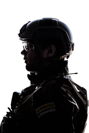 Silhouette of young soldier in military helmet on white backgroundの写真素材