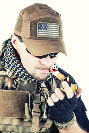 Studio shot of private military contractor PMC smoking a cigarの写真素材