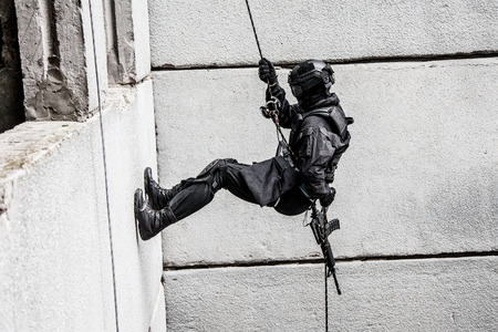 Spec ops police officer SWAT during rope exercises with weaponsの写真素材