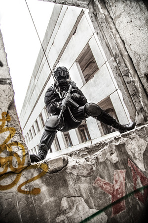 Spec ops police officer SWAT during rope exercises with weaponsの写真素材