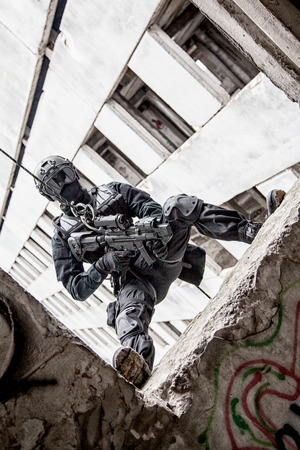 Spec ops police officer SWAT during rope exercises with weaponsの写真素材